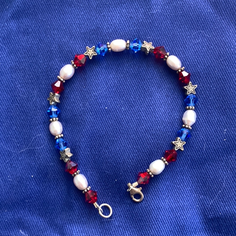 Red white and blue bracelet with pearls interspersed.